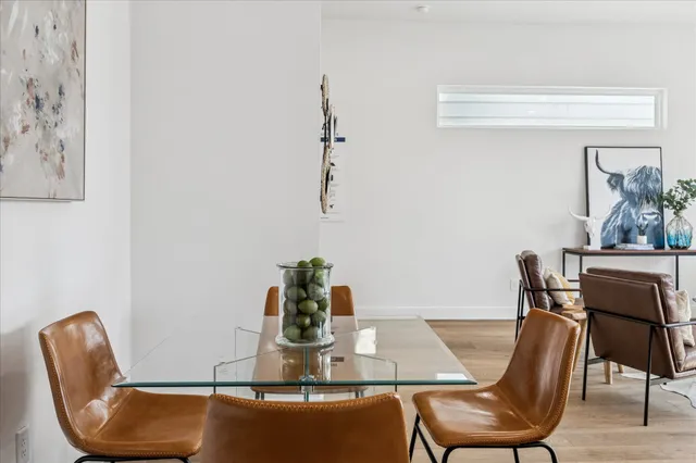 a dining room with furniture and wooden floor