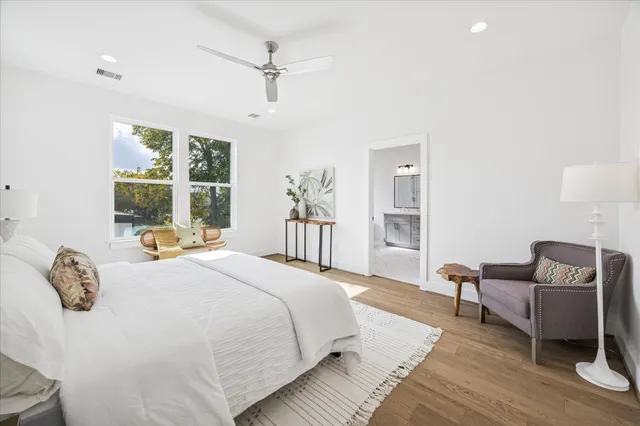 a spacious bedroom with a bed and a couch