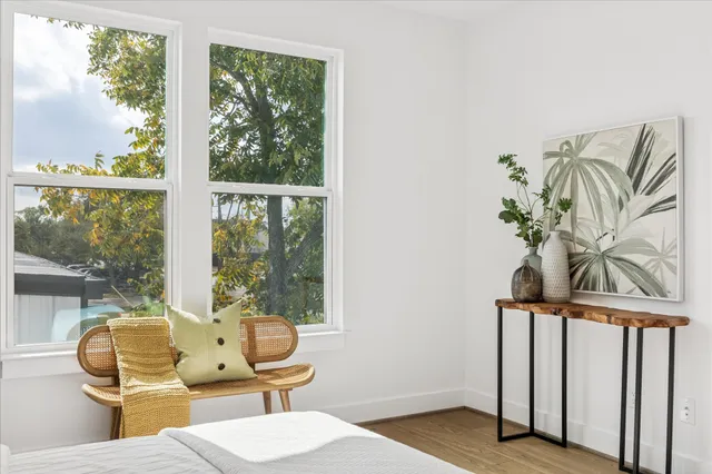 a view of a bedroom with furniture and windows
