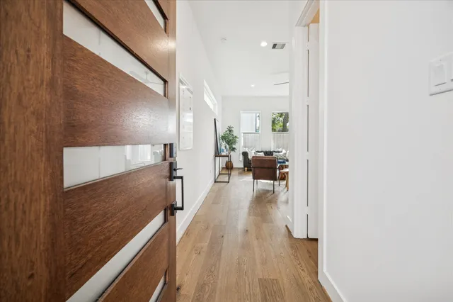 a view of a hallway with wooden floor