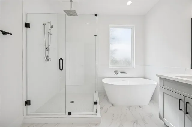 a bathroom with a bathtub and a shower