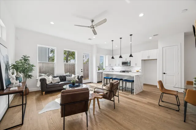 a living room with furniture and a wooden floor