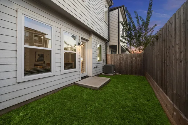 a view of backyard of house with green space