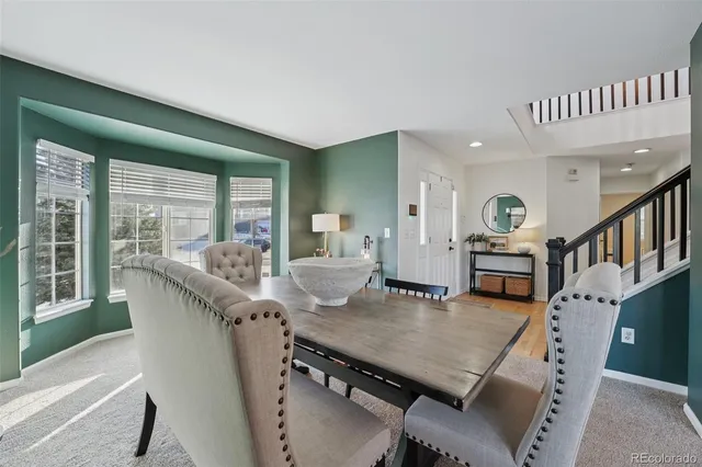 a living room with furniture wooden floor and a table