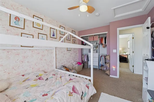 a bedroom that has a bed and a white comforter