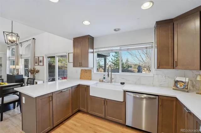 a kitchen with a sink window and cabinets