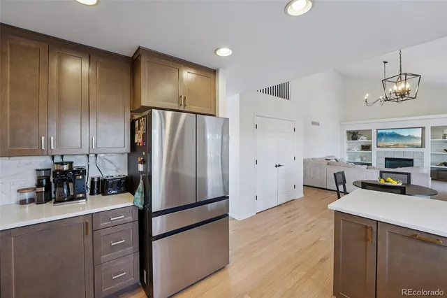 a kitchen with stainless steel appliances a refrigerator and a stove top oven