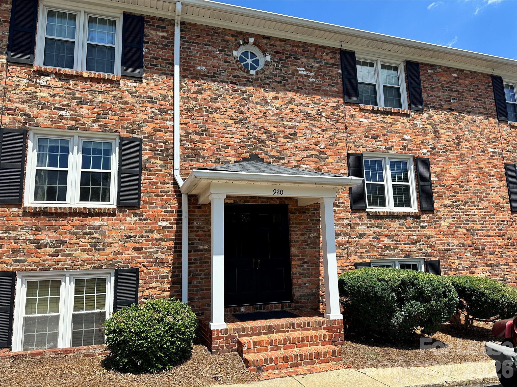a view of a brick house with a large windows