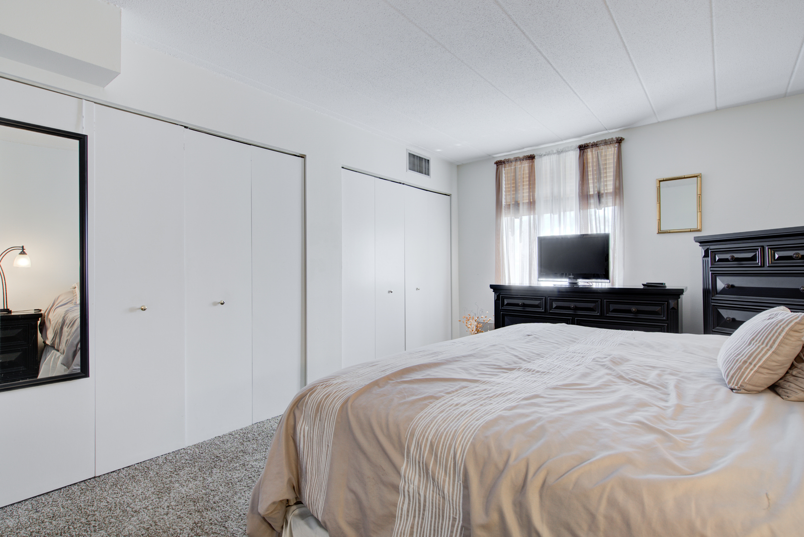 100 West Butterfield Road, Unit 512N Elmhurst, IL 60126 - Photo 9 of 16 a bed room with a bed and a television