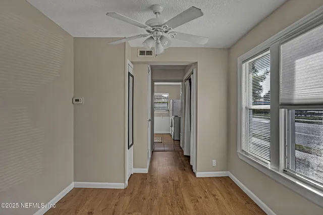 wooden floor in an empty room with a window