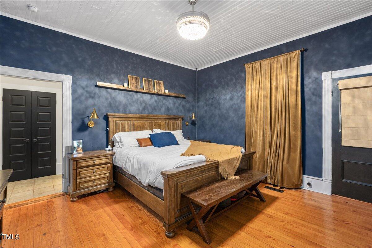 26 Oak Street Roxboro, NC 27573 - Photo 25 of 56 a bedroom with a bed and a dresser