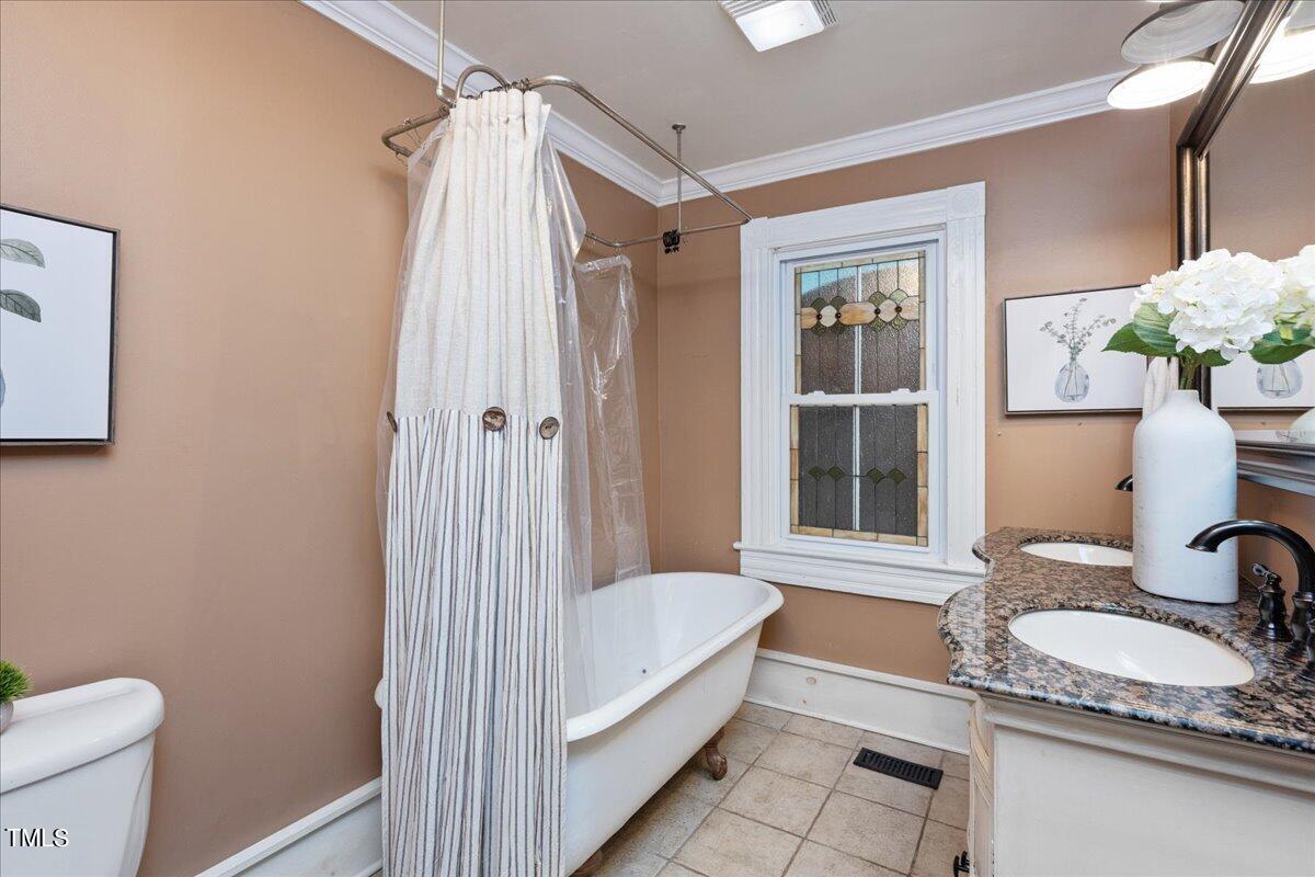 26 Oak Street Roxboro, NC 27573 - Photo 27 of 56 a bathroom with a granite countertop sink and a mirror