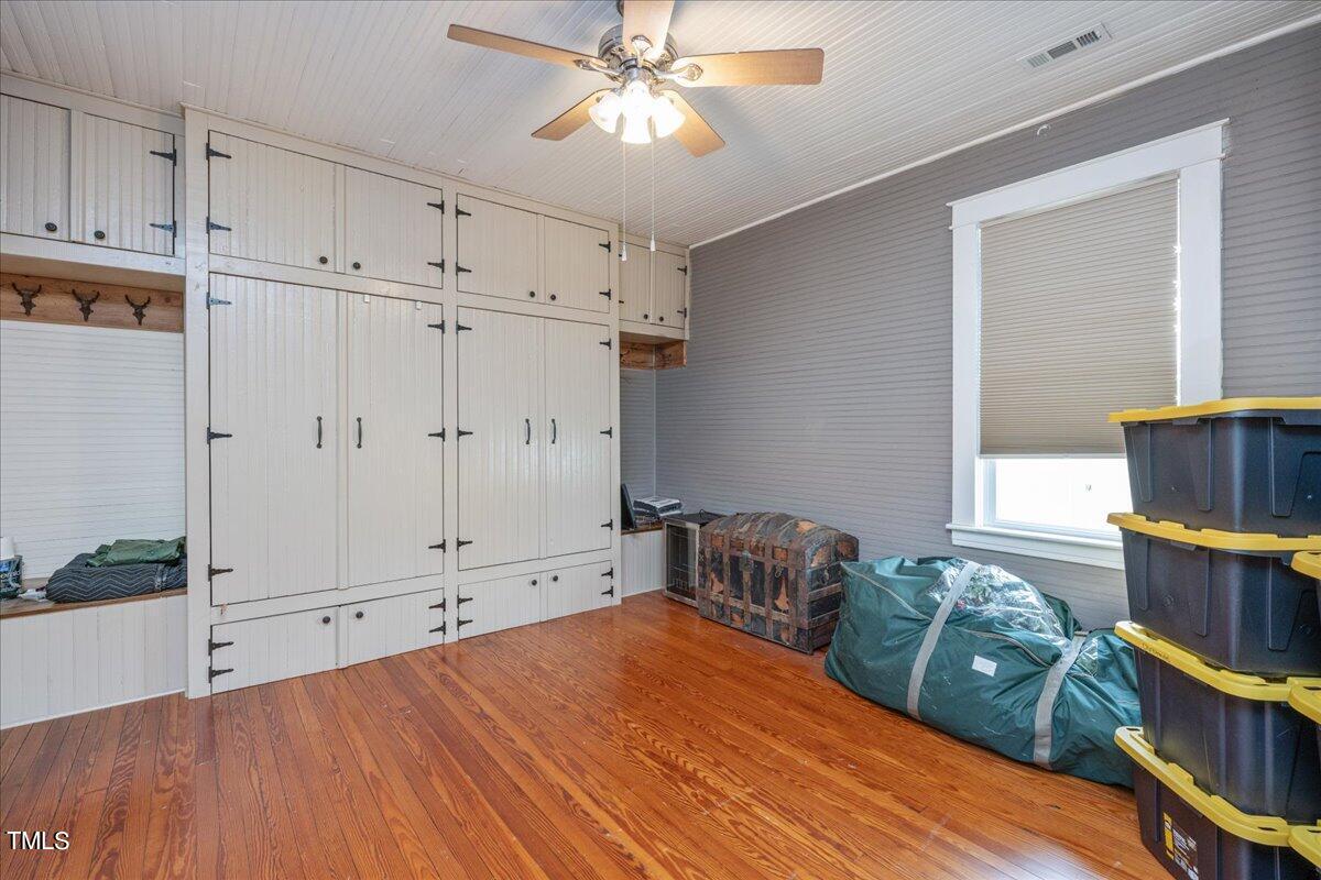 26 Oak Street Roxboro, NC 27573 - Photo 32 of 56 a bedroom with furniture and a book shelf