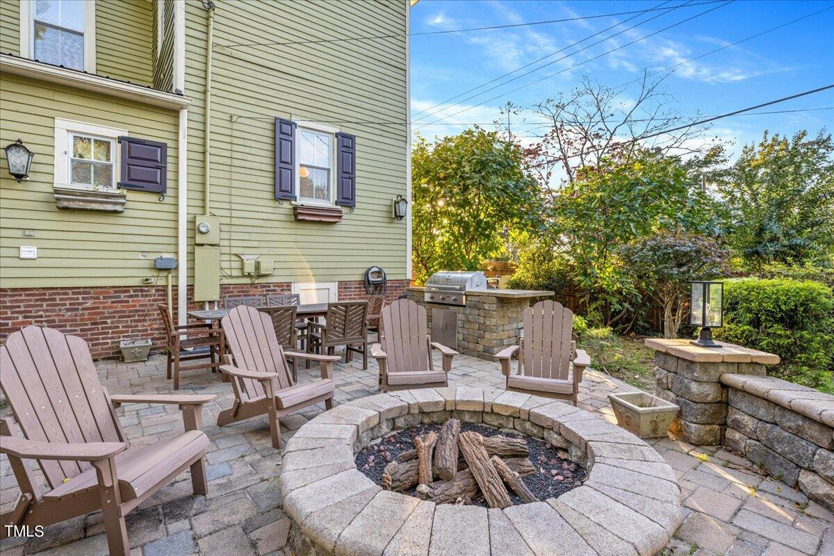 26 Oak Street Roxboro, NC 27573 - Photo 39 of 56 a view of a patio with table and chairs and potted plants