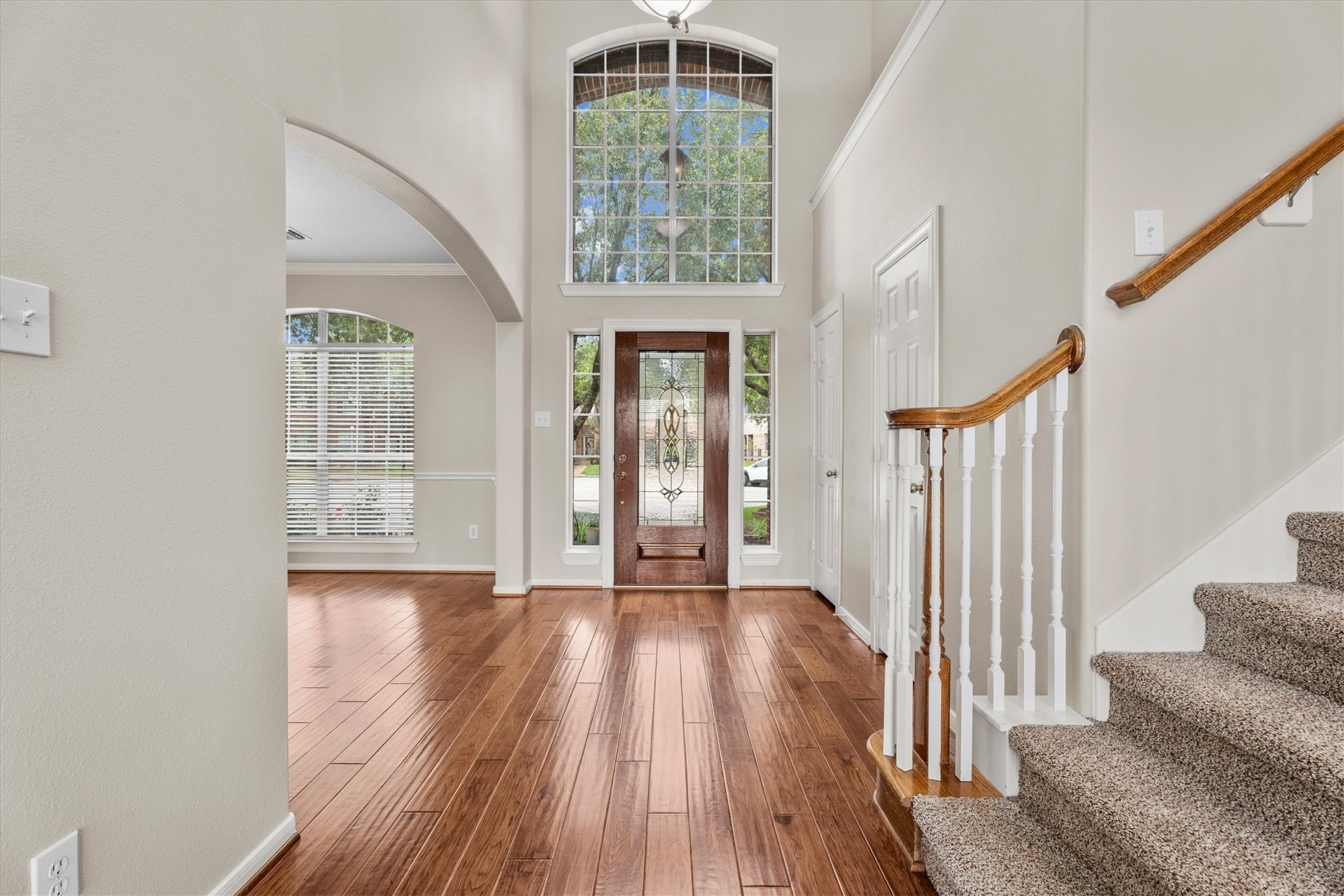 6323 Stone Trail Lane Spring, TX 77379 - Photo 6 of 43 a view of an entryway with wooden floor leading to a furnished livingroom