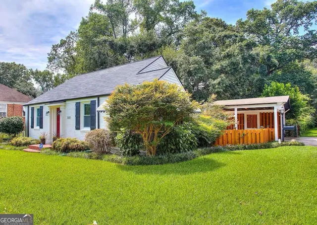 a front view of house with yard and green space