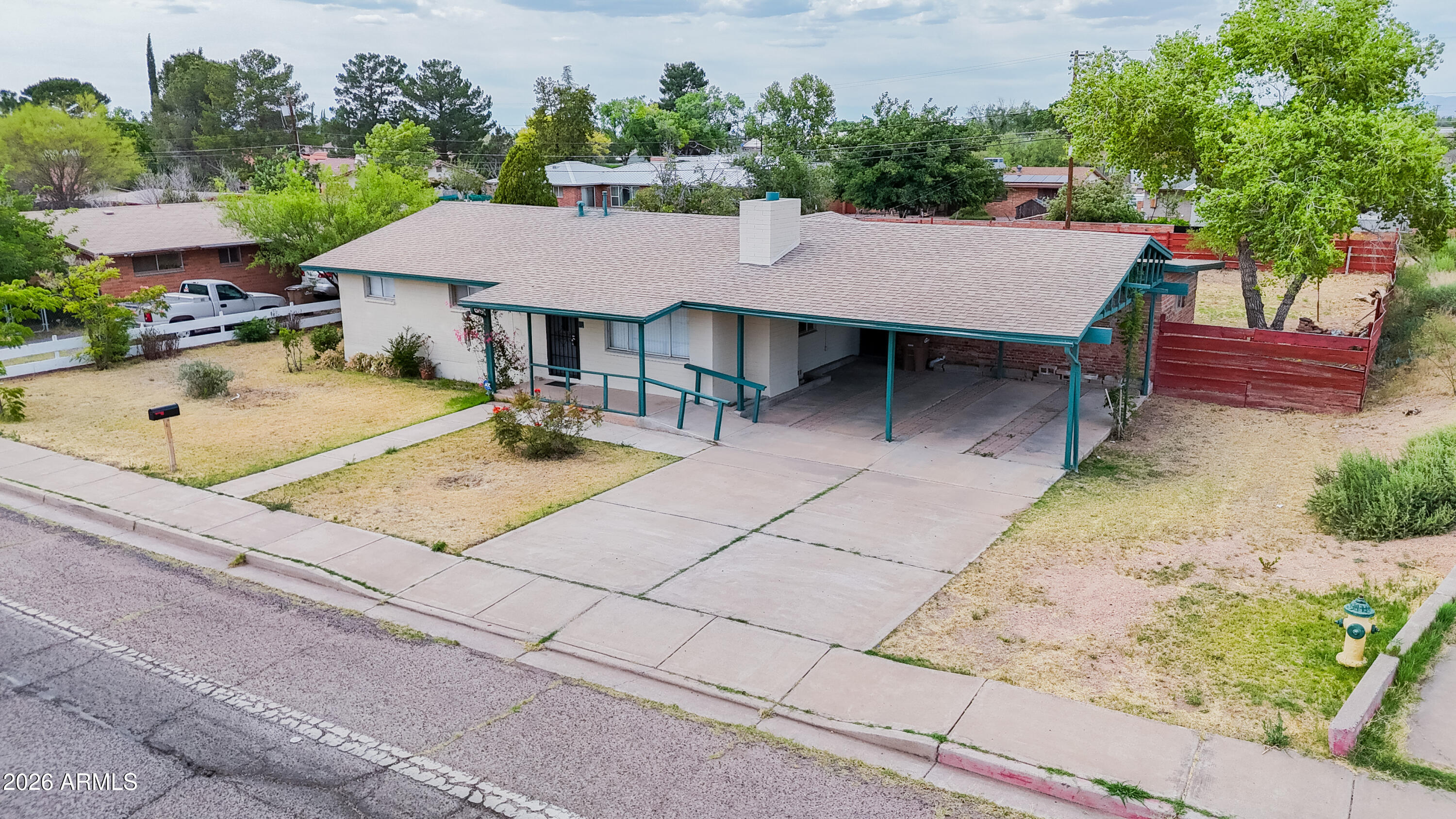 1626 11th Street Douglas, AZ 85607 - Photo 3 of 30 a view of a patio with a table and chairs under an umbrella