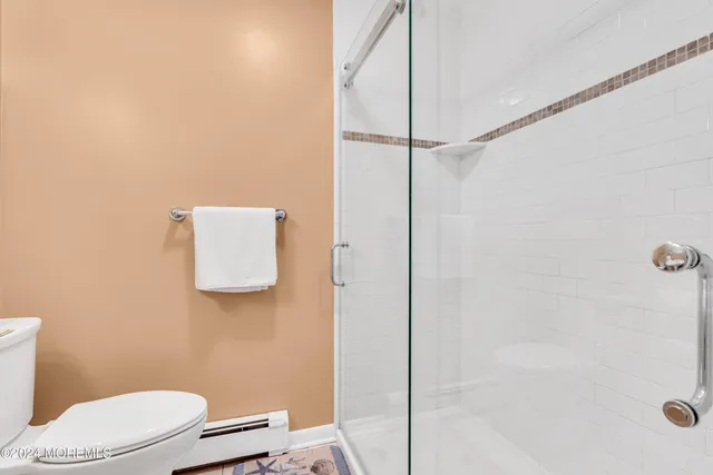 a living room with furniture ceiling fan and a book shelf