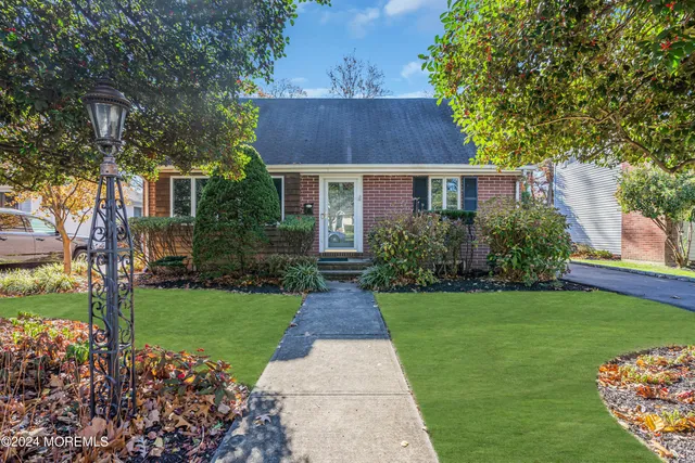 a dining room with furniture a chandelier and wooden floor
