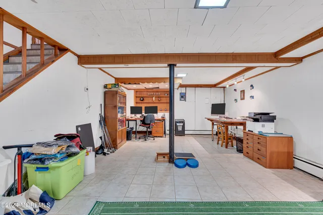 a view of a patio with table and chairs and potted plants with wooden floor and fence