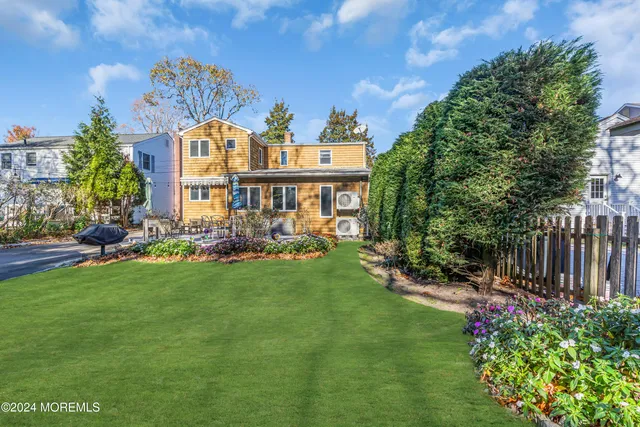 front view of a building with a tree