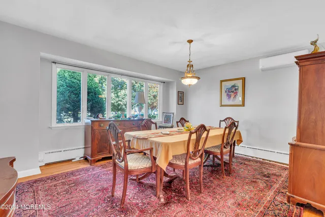 a open kitchen with stainless steel appliances kitchen island granite countertop a stove a sink a dining table and chairs