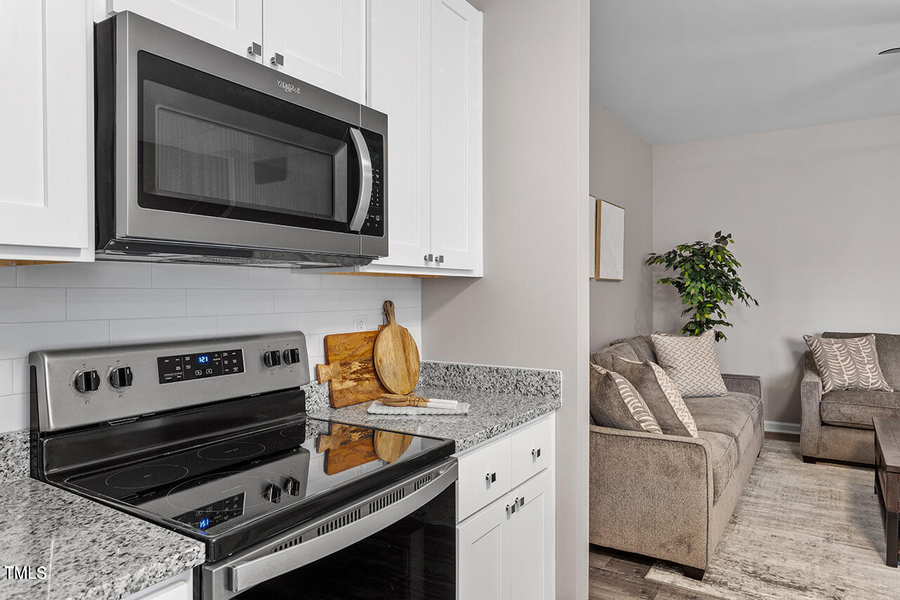 874 John Street Clayton, NC 27520 - Photo 13 of 25 a kitchen with a stove and a microwave