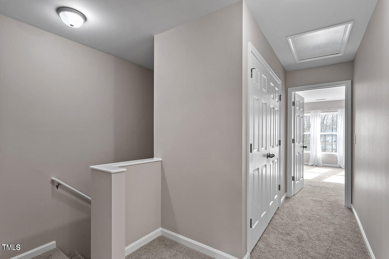 874 John Street Clayton, NC 27520 - Photo 14 of 25 a view of a hallway with wooden floor