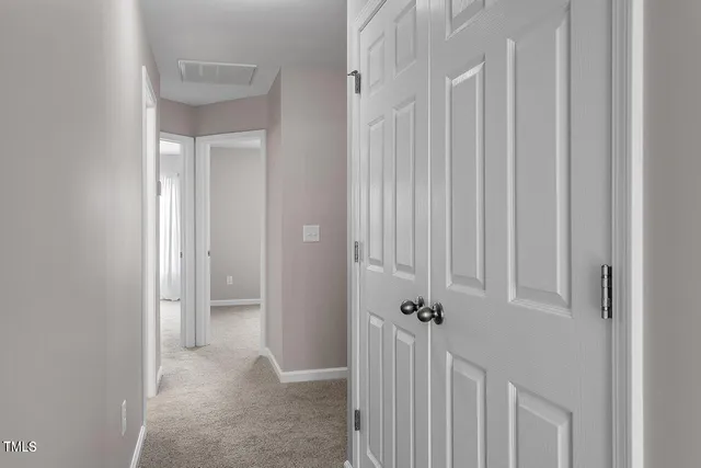 a view of a hallway with a door