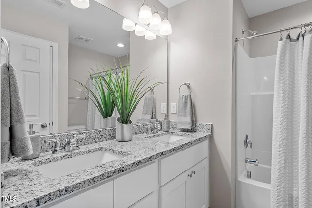 a bathroom with a granite countertop sink a vanity and a mirror