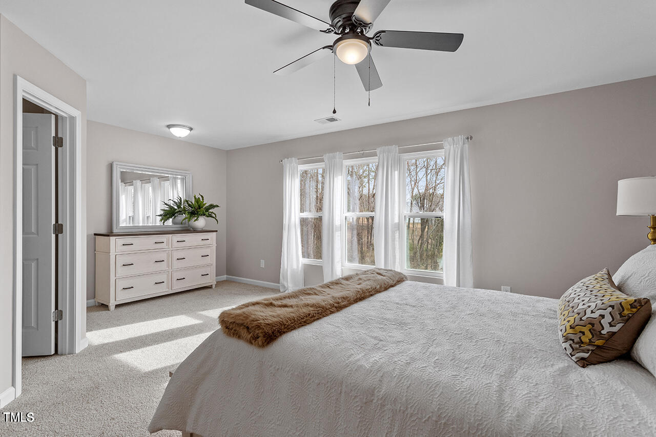 874 John Street Clayton, NC 27520 - Photo 20 of 25 a bedroom with a large bed and a window