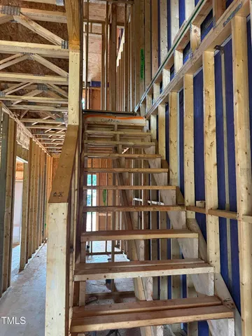 a view of staircase with white walls and a window