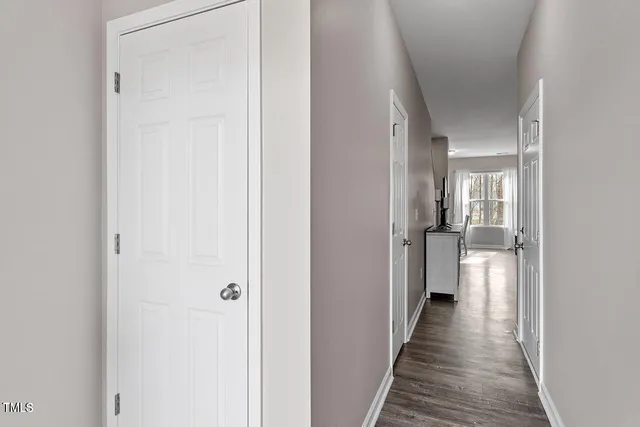 a view of a hallway with a wooden floor