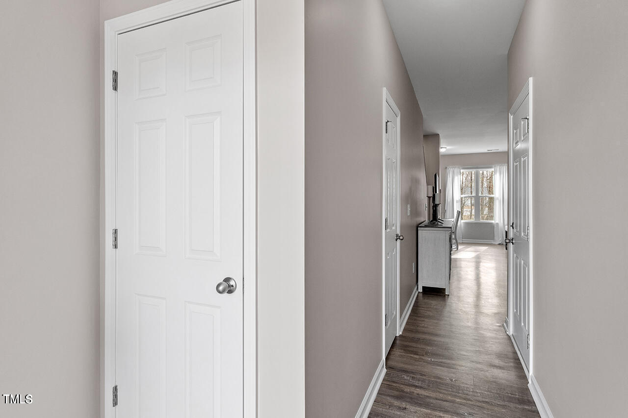 874 John Street Clayton, NC 27520 - Photo 6 of 25 a view of a hallway with a wooden floor