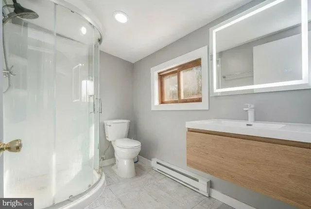 a bed sitting in a spacious bedroom next to a window