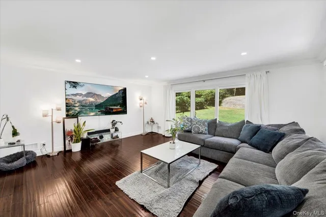 a view of a hallway with wooden floor and entryway