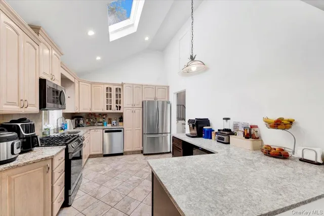 a kitchen with stainless steel appliances granite countertop a refrigerator sink and stove