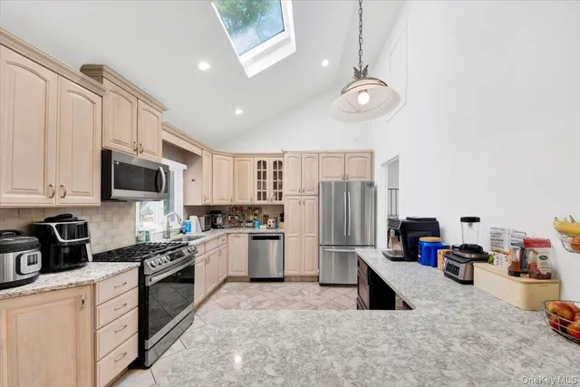 a kitchen with stainless steel appliances granite countertop a refrigerator sink and stove