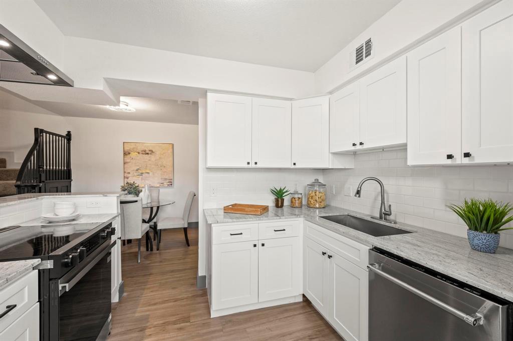 4247 Madera Road Irving, TX 75038 - Photo 11 of 28 a kitchen with a sink stove and cabinets