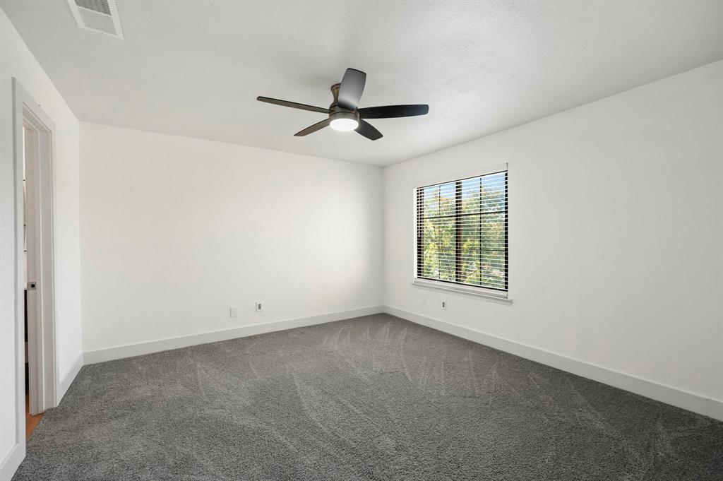 4247 Madera Road Irving, TX 75038 - Photo 13 of 28 an empty room with a window and a ceiling fan