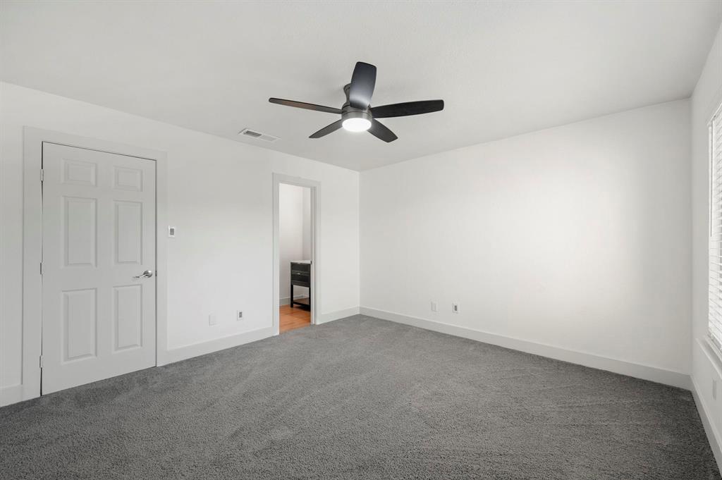4247 Madera Road Irving, TX 75038 - Photo 15 of 28 an empty room with a ceiling fan and window