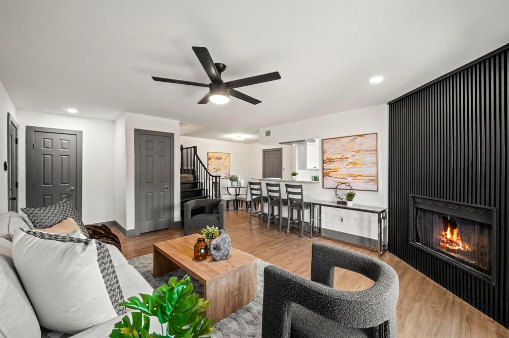 4247 Madera Road Irving, TX 75038 - Photo 4 of 28 a living room with furniture a fireplace and a flat screen tv
