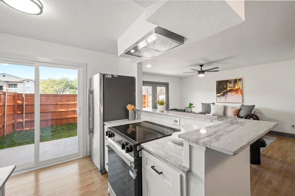 4247 Madera Road Irving, TX 75038 - Photo 10 of 28 a kitchen that has a sink a stove and a refrigerator