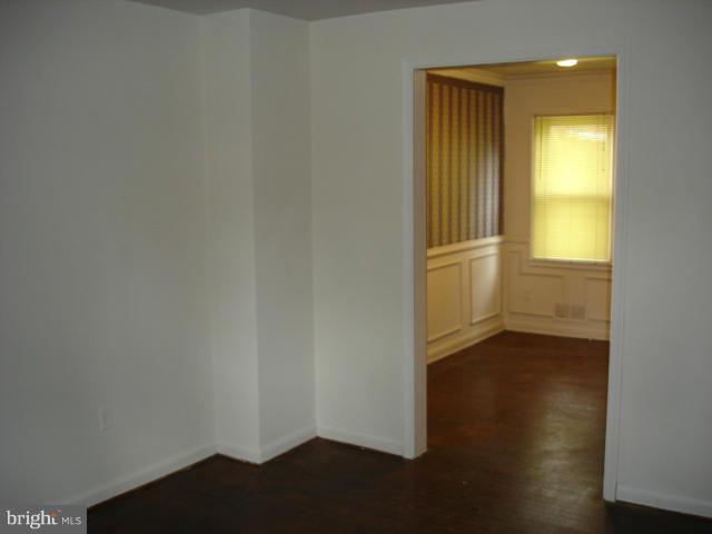1061 Cameron Road Baltimore, MD 21212 - Photo 3 of 8 an empty room with wooden floor and windows