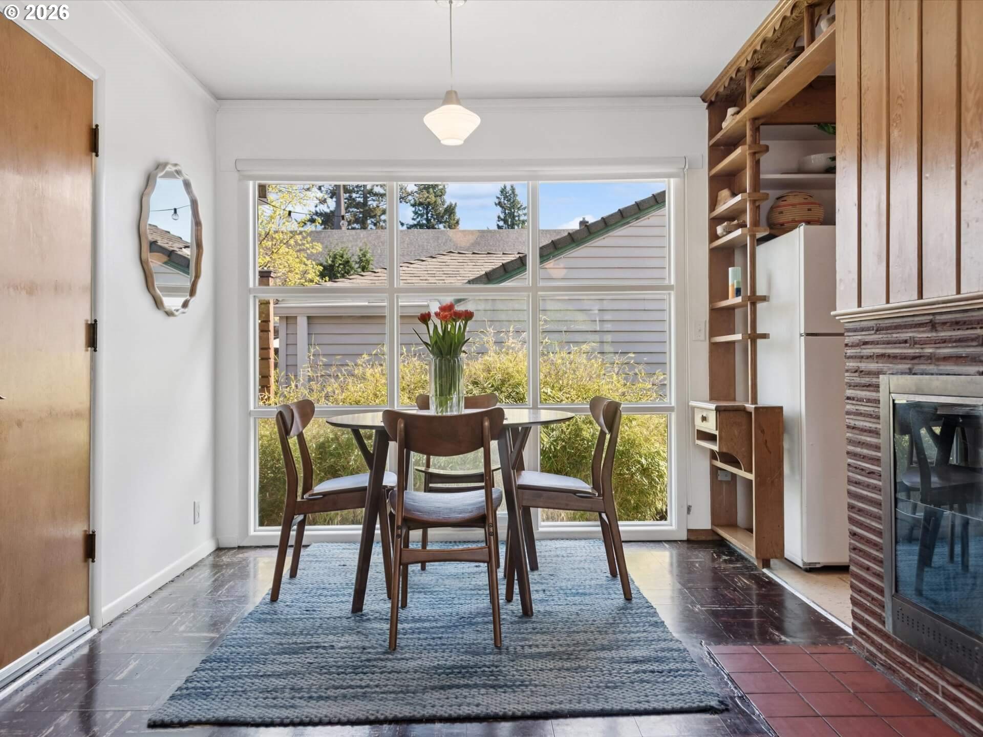 6030 Southeast 80th Avenue Portland, OR 97206 - Photo 12 of 42 a dining room with furniture a rug a fireplace and wooden floor