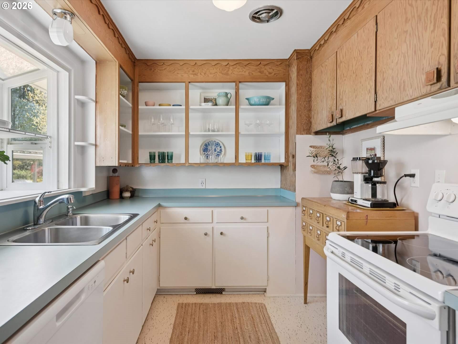 6030 Southeast 80th Avenue Portland, OR 97206 - Photo 15 of 42 a kitchen with a sink stove top oven and cabinets