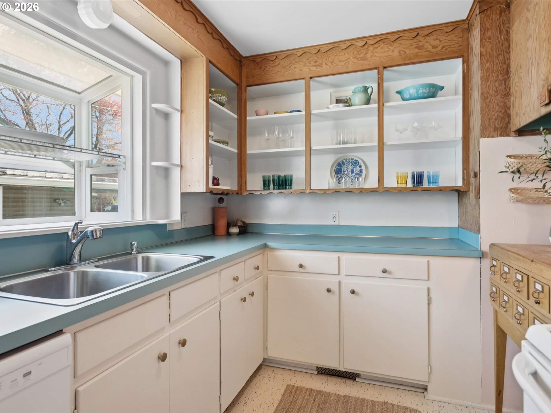6030 Southeast 80th Avenue Portland, OR 97206 - Photo 16 of 42 a kitchen with white cabinets and a large window