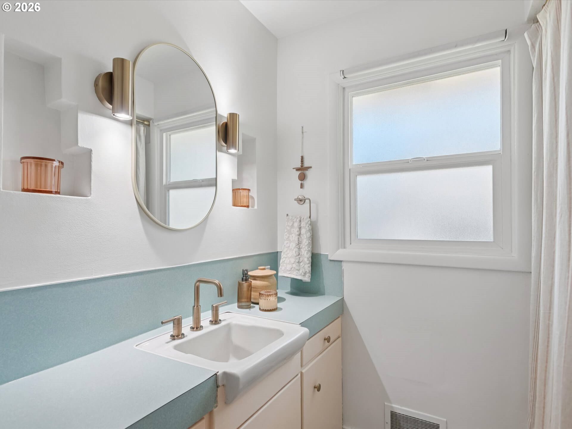 6030 Southeast 80th Avenue Portland, OR 97206 - Photo 29 of 42 a bathroom with a sink a mirror a vanity and a window