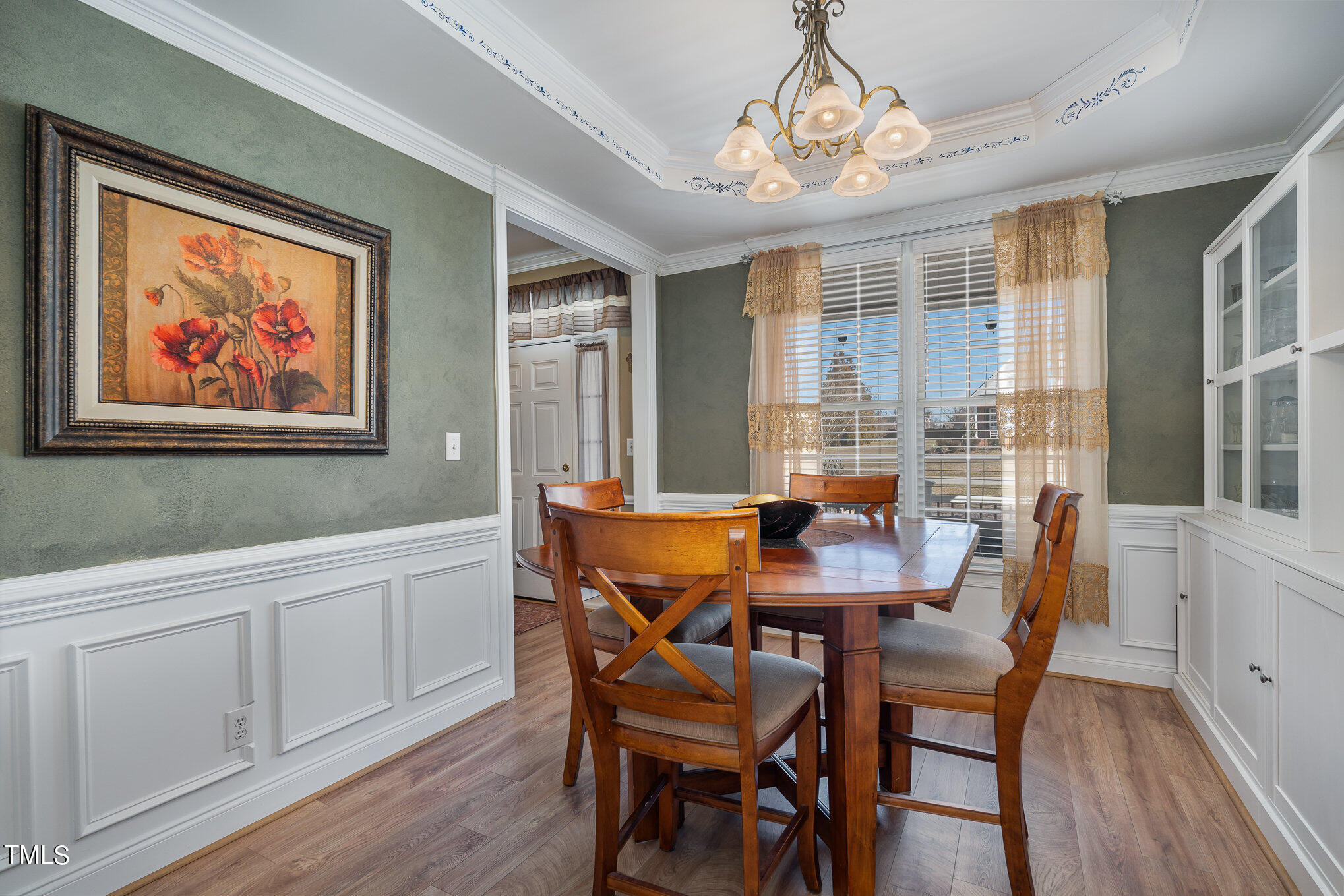 4520 Deer Stream Lane Raleigh, NC 27603 - Photo 15 of 35 a view of a dining room with furniture large window and wooden floor