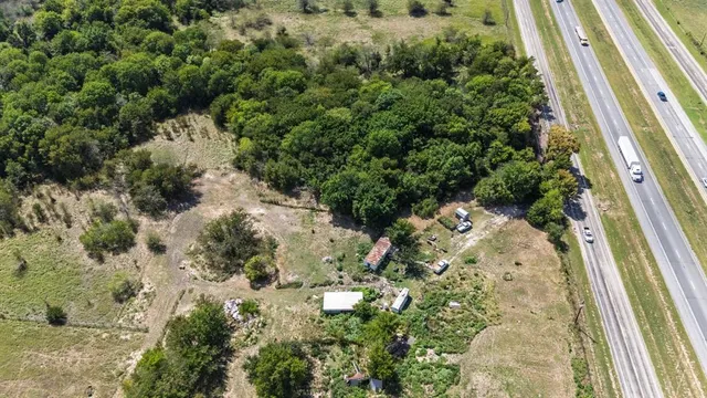 a view of a garden with a house